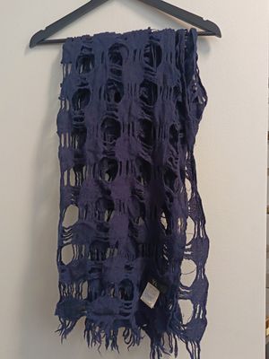 a purple scarf hanging on a wall in a room