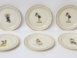 six plates with different designs of people on them on a white surface