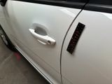 a close up of a car door handle with a sticker on it