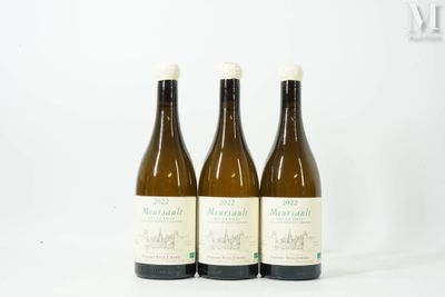 three bottles of wine sitting next to each other on a white surface