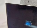 a flat screen tv sitting on top of a wooden stand