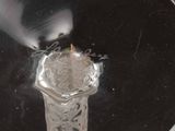 a glass vase with a flower in it on a table