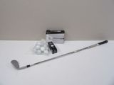 a golf club and a box of golf balls on a table