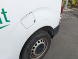 a white van with green lettering parked on the side of the road