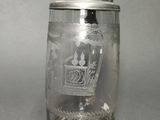 a glass jar with a lid that has a picture on it