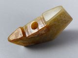 a small boat shaped object on a white surface