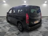the back of a black minivan parked in a garage