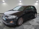 the black volkswagen polo is parked on a checkered tile floor