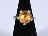 a close up of a ring with a large citrine stone on it
