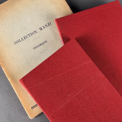 two red books sitting on top of a table next to each other