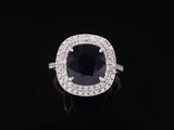 a black and white diamond ring on a black background