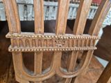 a close up of a wooden chair with a name plate on it