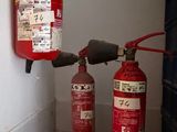 deux extincteurs accrochés au mur l'un à côté de l'autre