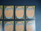 six decks of magic the gathering cards on a table