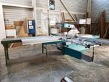 a machine that is cutting a piece of wood in a room