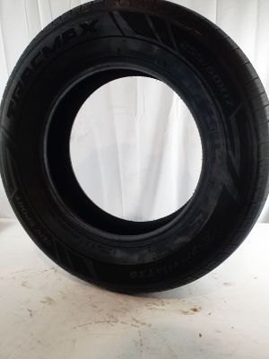 a close up of a tire on a white surface with a white curtain in the background