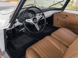a white car with brown leather seats and a steering wheel