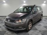 the grey volkswagen touran is parked in a large room