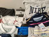 a pile of clothing that is sitting on a bed