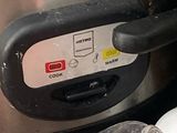 a close up of a crock pot and a bottle of beer
