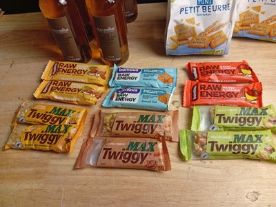many snacks and drinks sitting on a table next to each other