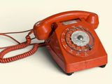 a red telephone that is sitting on a table