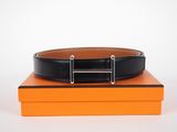 a close up of a black belt on top of an orange box