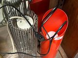 a red bucket sitting on the floor next to two red buckets