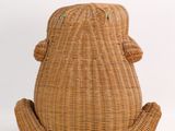 a brown rattan bag sitting on top of a white table