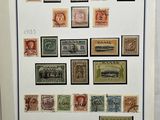 an old picture of a collection of stamps on display in a frame