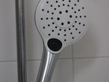 a close up of a shower head in a bathroom