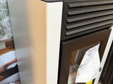 a black and white stove sitting in a kitchen next to a refrigerator