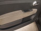 the door handle of a car with a tan seat cover