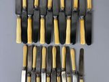a lot of different types of knives on the table