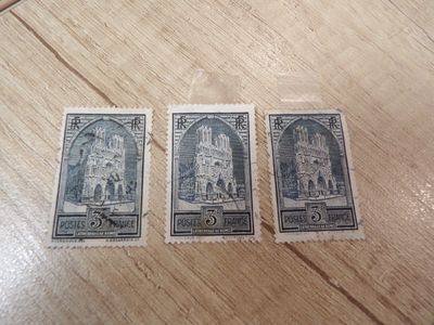 three stamps with a picture of a church on them sitting on a table