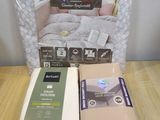 two boxes of bedding on a wooden table