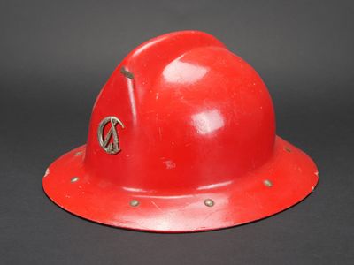 un casque de chantier rouge posé sur une table