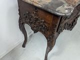 a small table with a marble top in a room