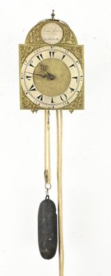a clock with a pendulum hanging from the side of it