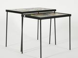 the two tables are made out of metal and have different designs