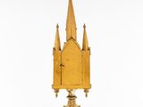 an old wooden clock with a spire on top of it
