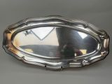 a silver tray with a mirror on it on a table