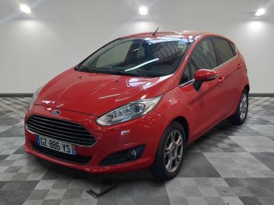 the red ford fiesta is parked in a large room