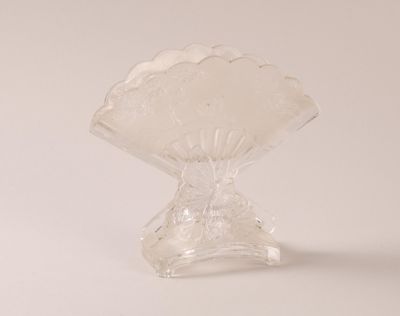 a clear glass vase with a scallop design on it