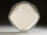 an image of a silver plate with a decorative design on it