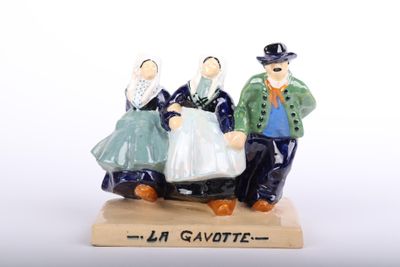 a figurine of a man and a woman on a sled