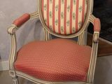 a red and white striped chair in the corner of a room