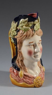 a ceramic figurine of a woman with a crown on her head