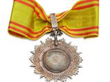 medal with a red and yellow ribbon and a star on it