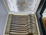 a box with a set of silver spoons inside of it